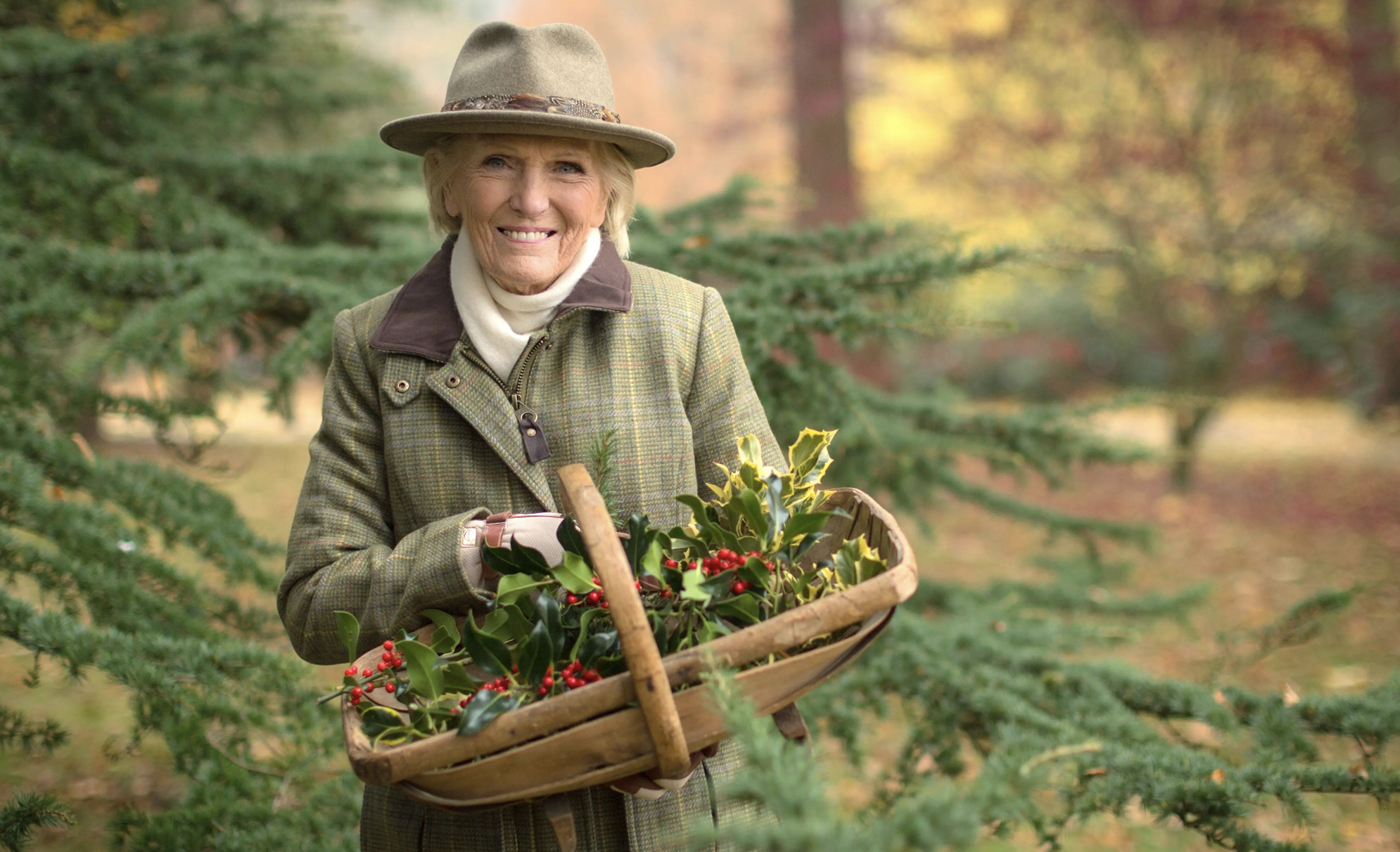 British cook Mary Berry holding a basket of holly