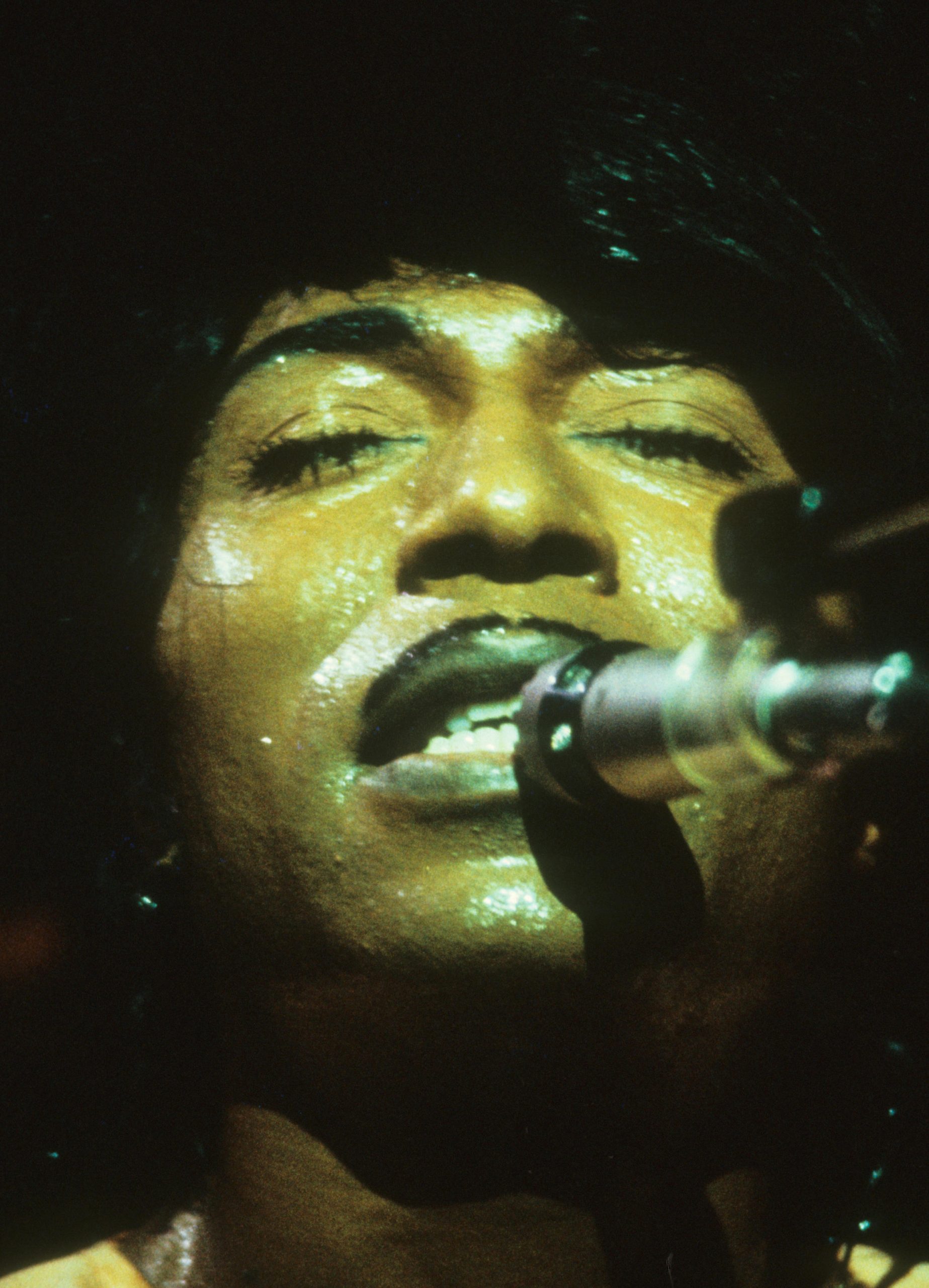 A black and white up-close picture of Little Richard performing in 1976.